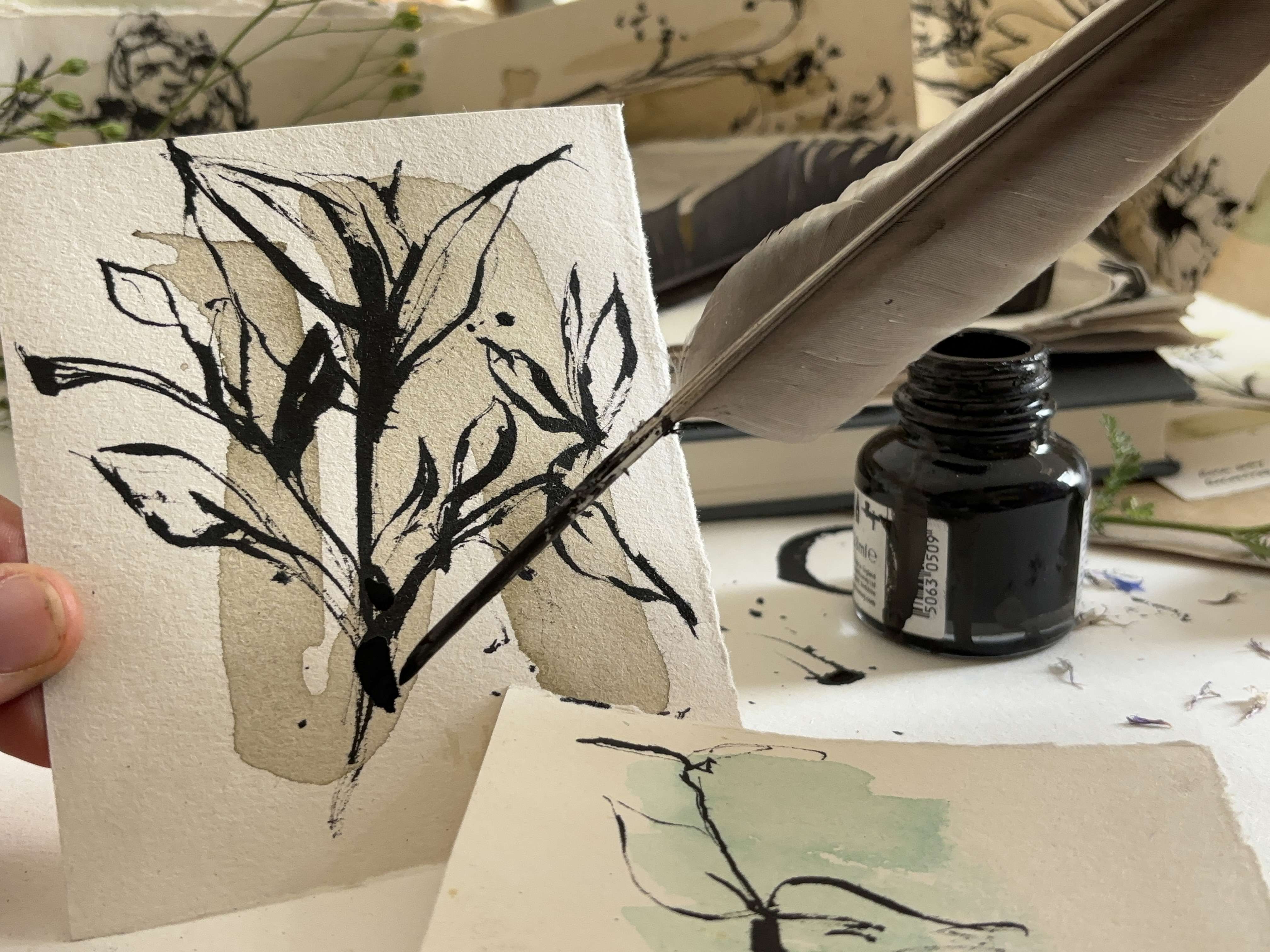 Feather Quill illustration a winter tree in black ink on white paper with ink bottle in the background