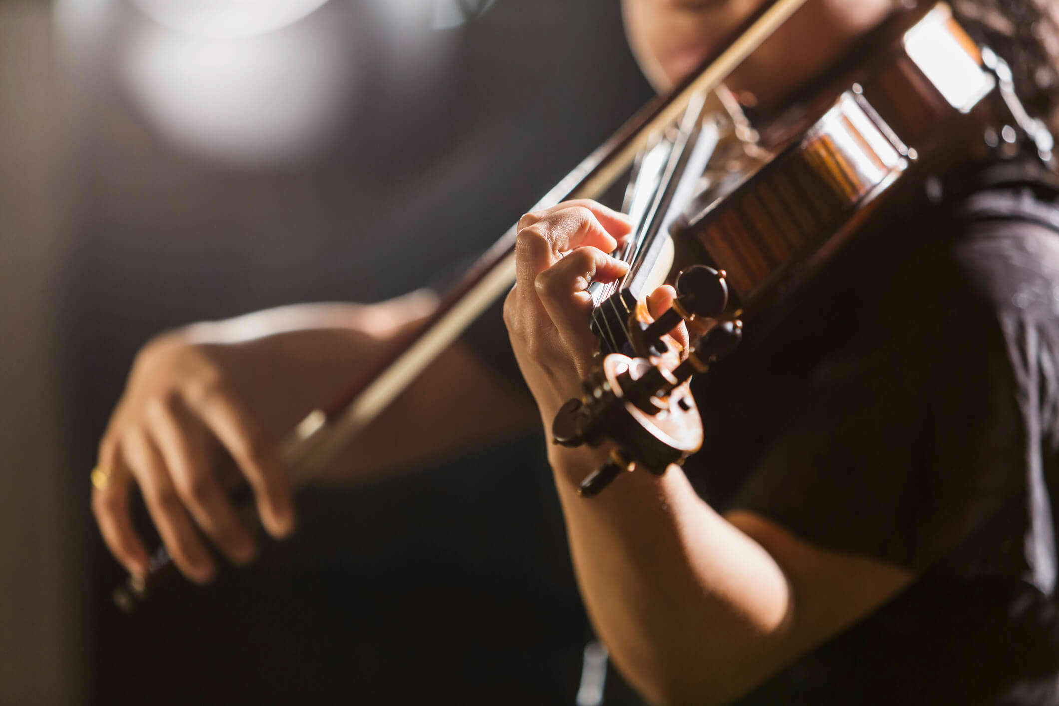 a close up of someone playing the violin