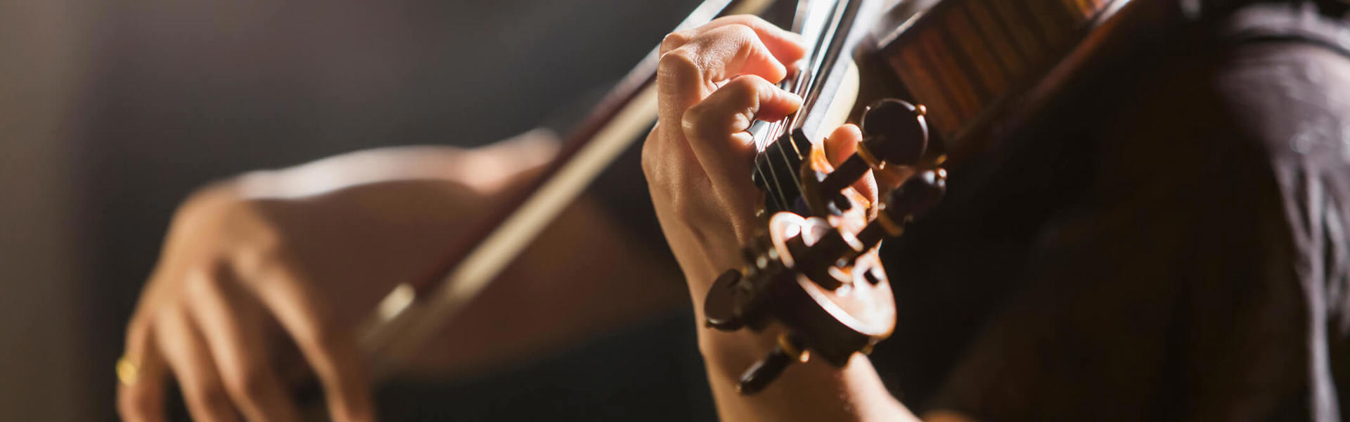 a close up of someone playing the violin