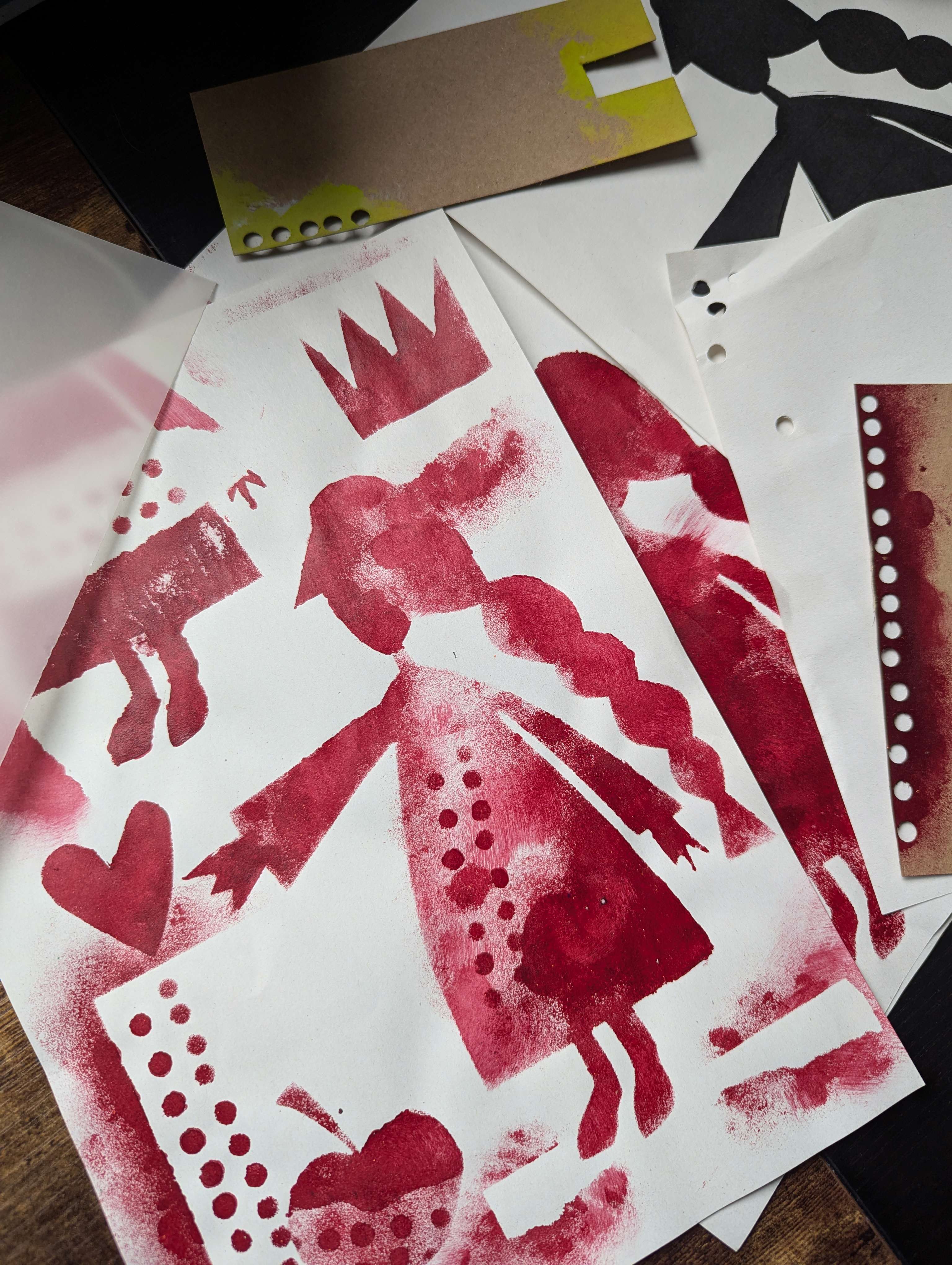 Main Image: A simple stencil art collage in red acrylic paint - stencil of a lady, apple, crown and abstract shapes.