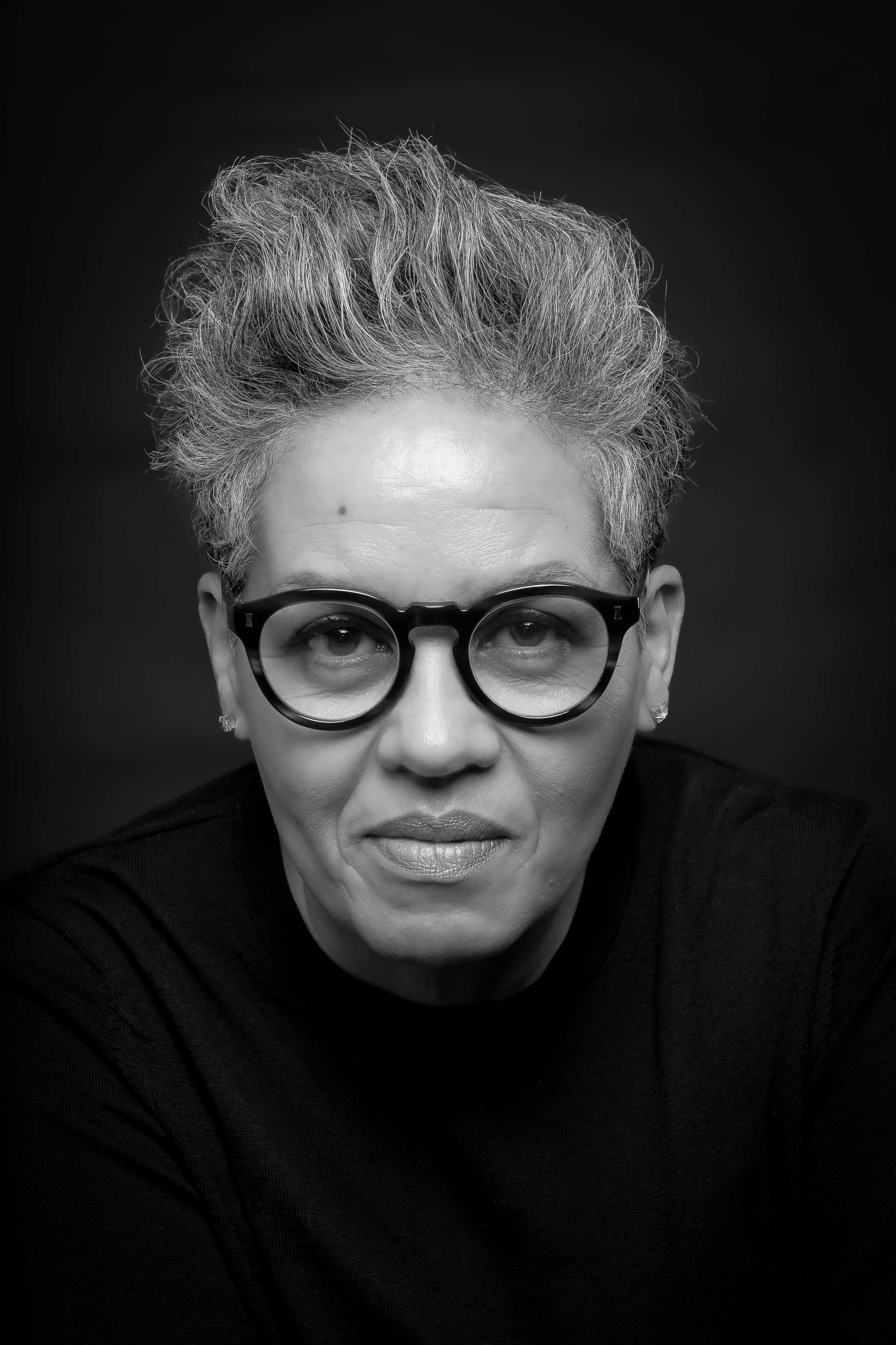 Main image: black and white headshot photo of novelist and author Kit de Waal, wearing glasses looking into the camera.