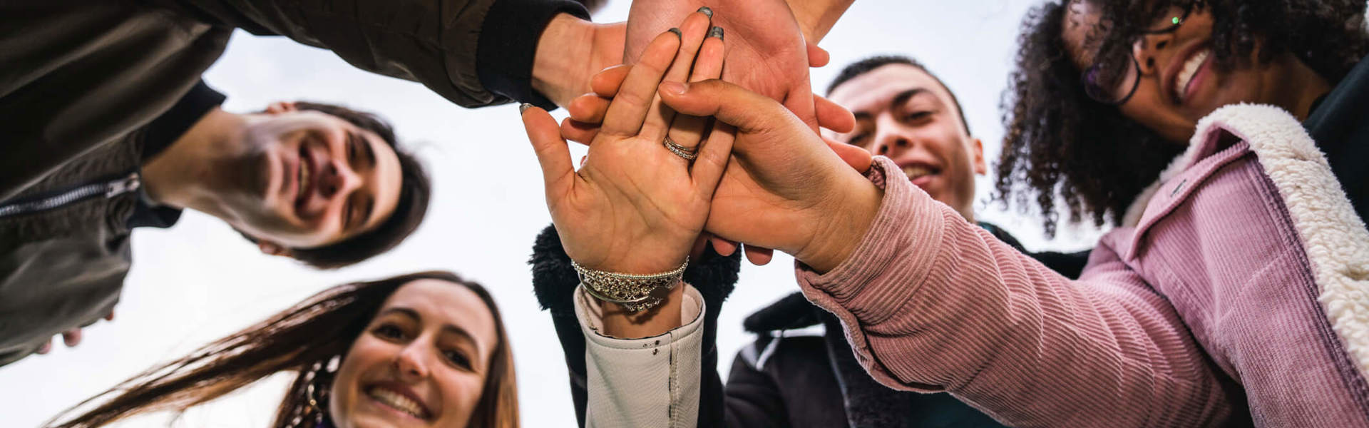 A group of supporters crossing hands