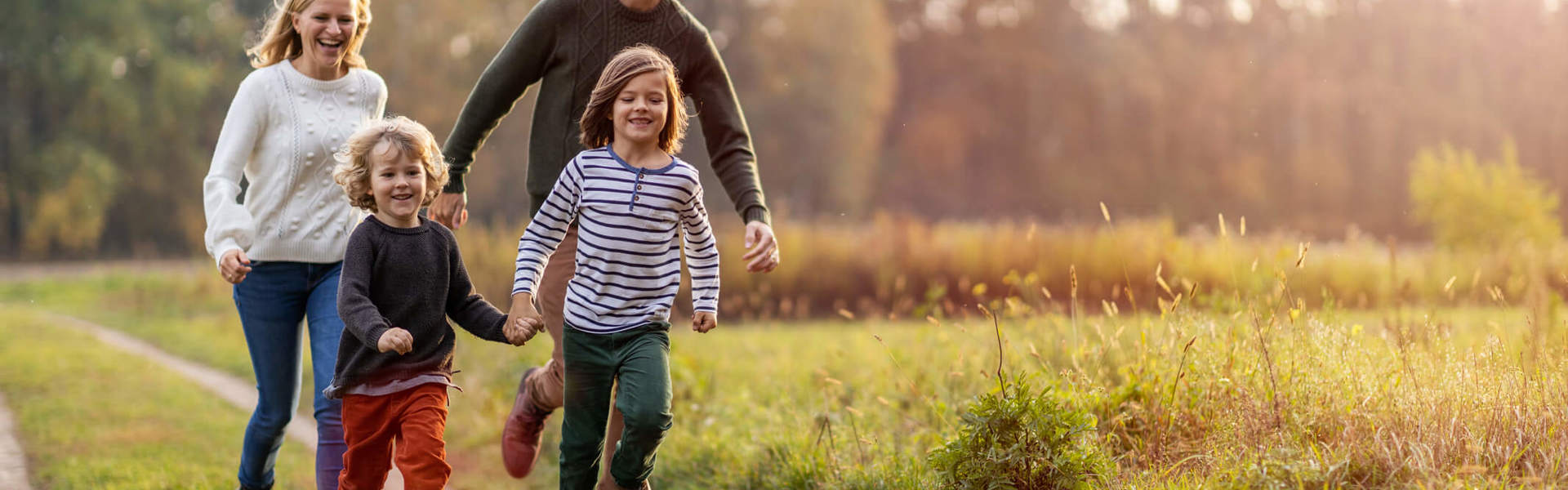 a family of four enjoying a country walk wearing wellies