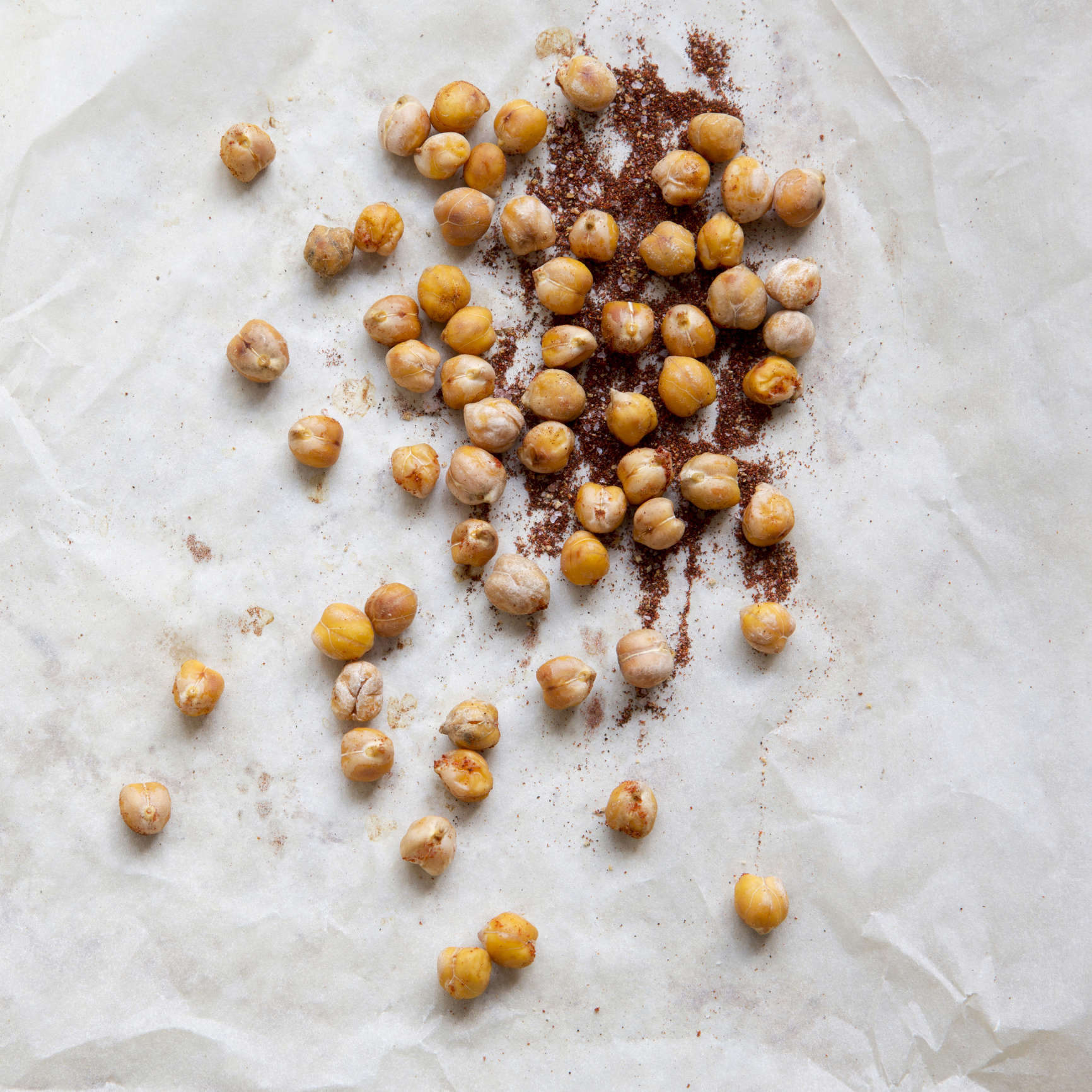 Main image: chickpeas and spices on greaseproof paper, ready to make a healthy snack - crispy chickpea biscuits.