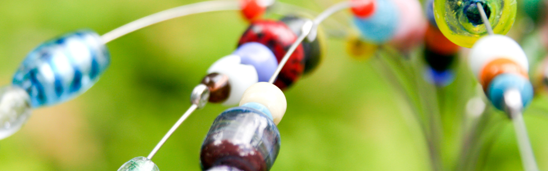 a close up of an assortment of colourful beads on a wire