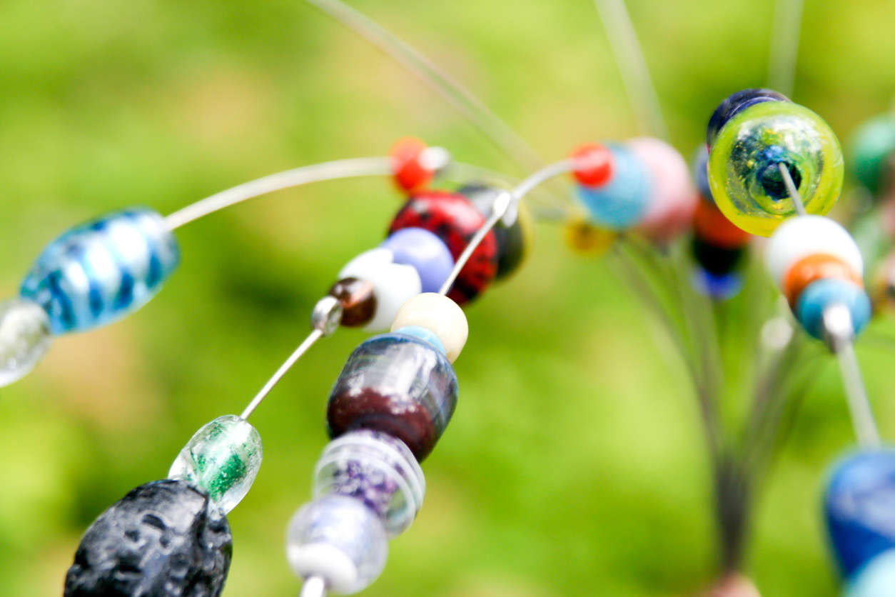 a close up of an assortment of colourful beads on a wire