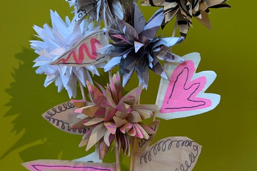 Recycled Scrap Paper Flower Bouquet, against a green background