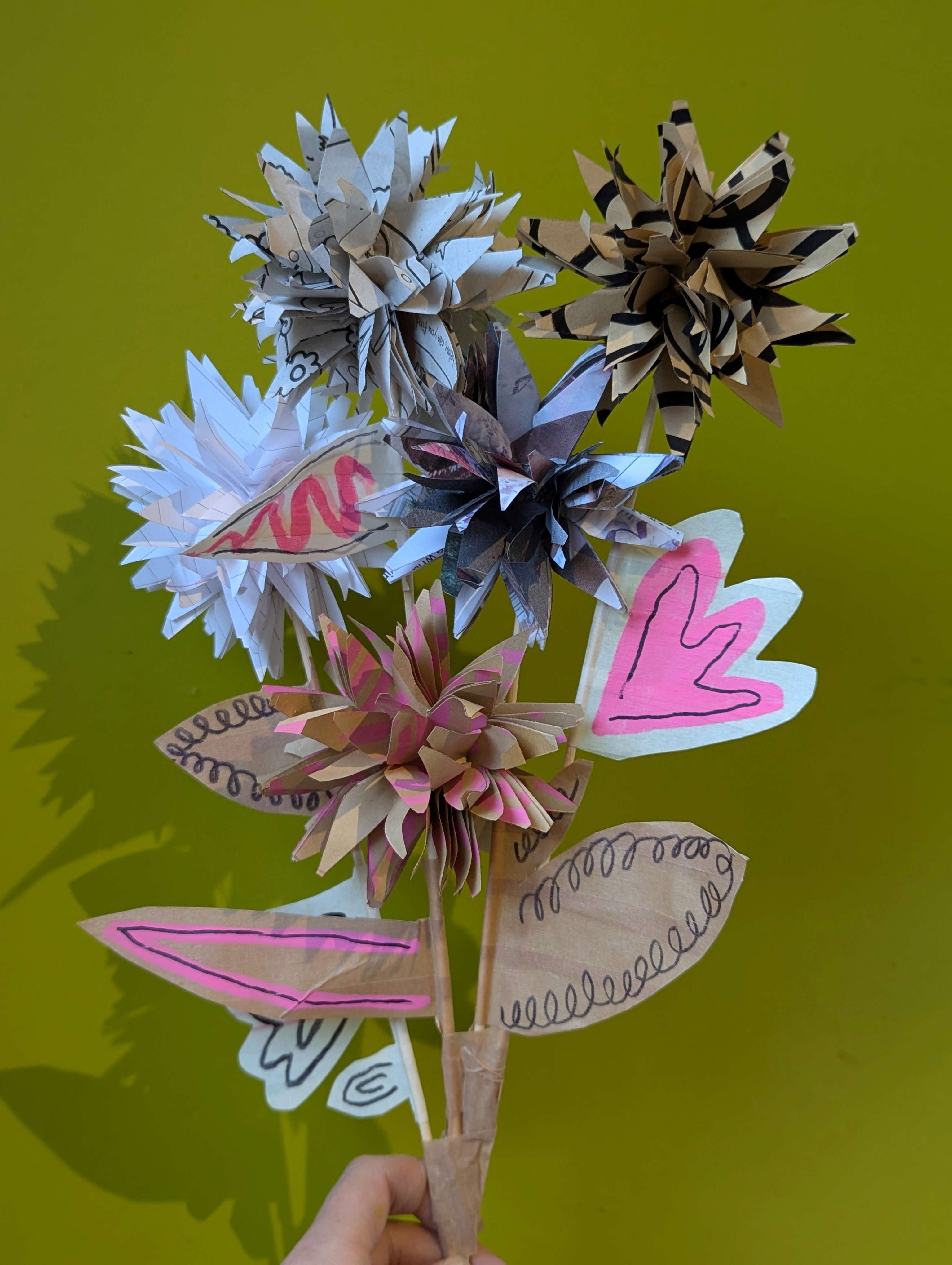 Recycled Scrap Paper Flower Bouquet, against a green background