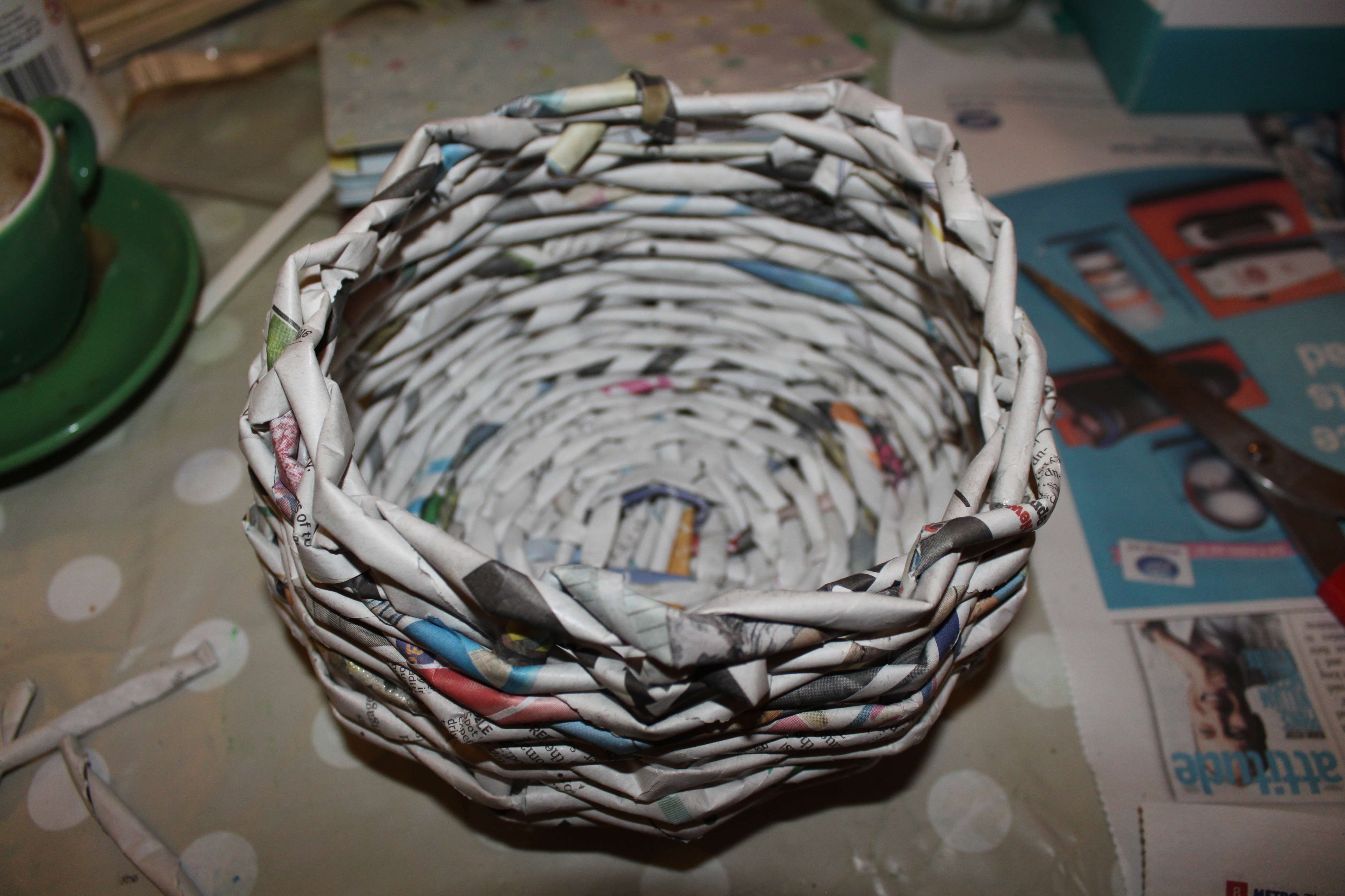 a close up of a handwoven newspaper basket made by Kim Searle