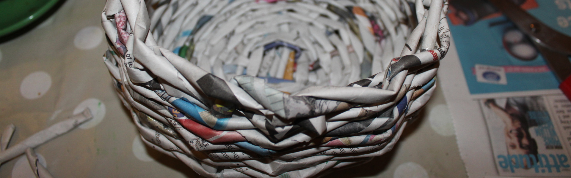 a close up of a handwoven newspaper basket made by Kim Searle