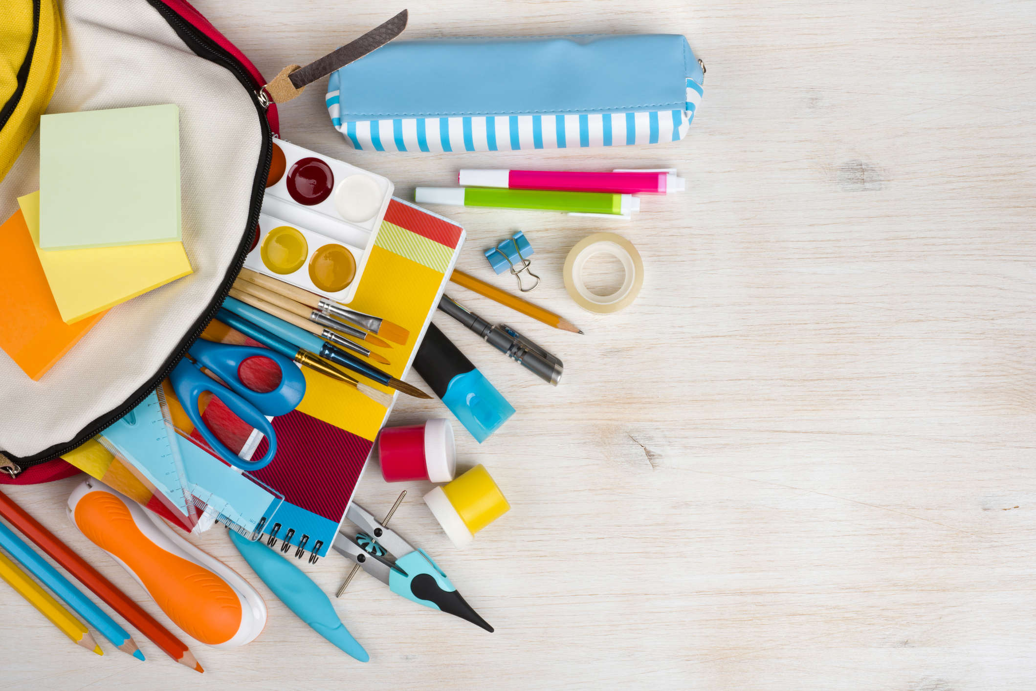 various craft materials on a white wooden table