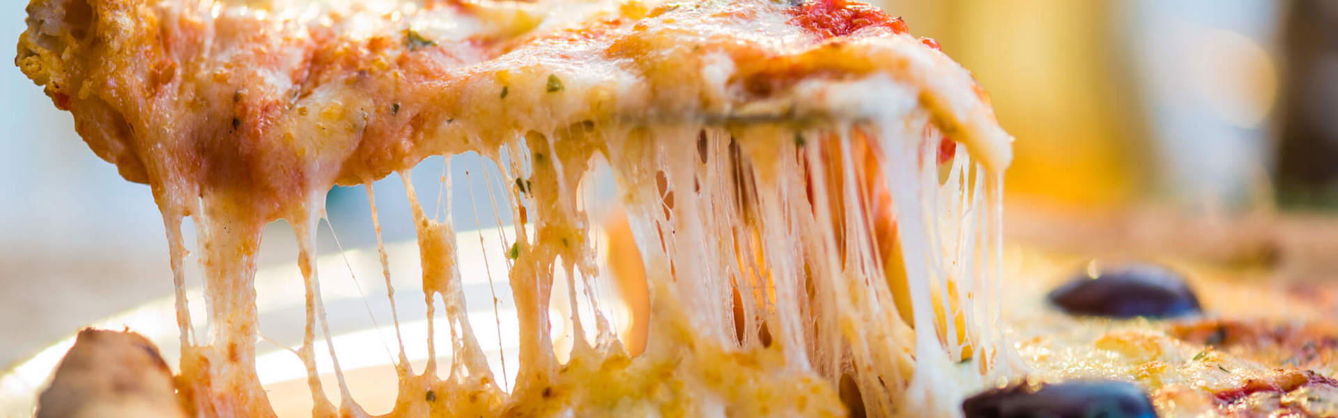 a close up of a slice of tomato and cheese pizza being served