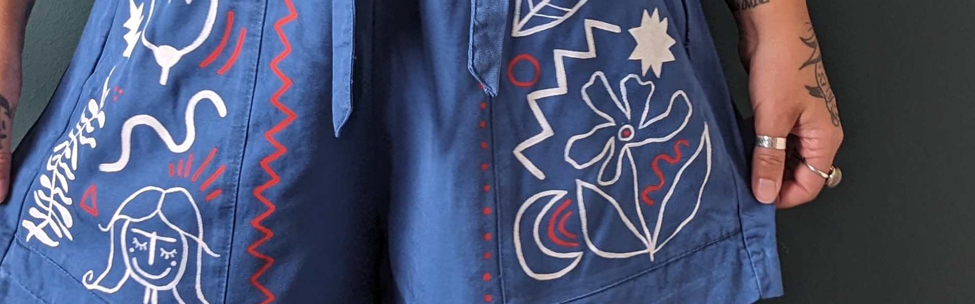 fabric painting on blue shorts by Rosie Johnson