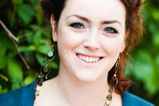 Close up photo of Megan Gimber, Key Habitats Officer at People’s Trust for Endangered Species (PTES). Megan is smiling with long dangly earrings and teal eyeliner to match her cardigan.