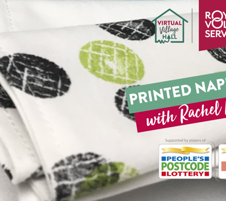 Hand printed green white and black polka dot napkin underneath a teacup and scone