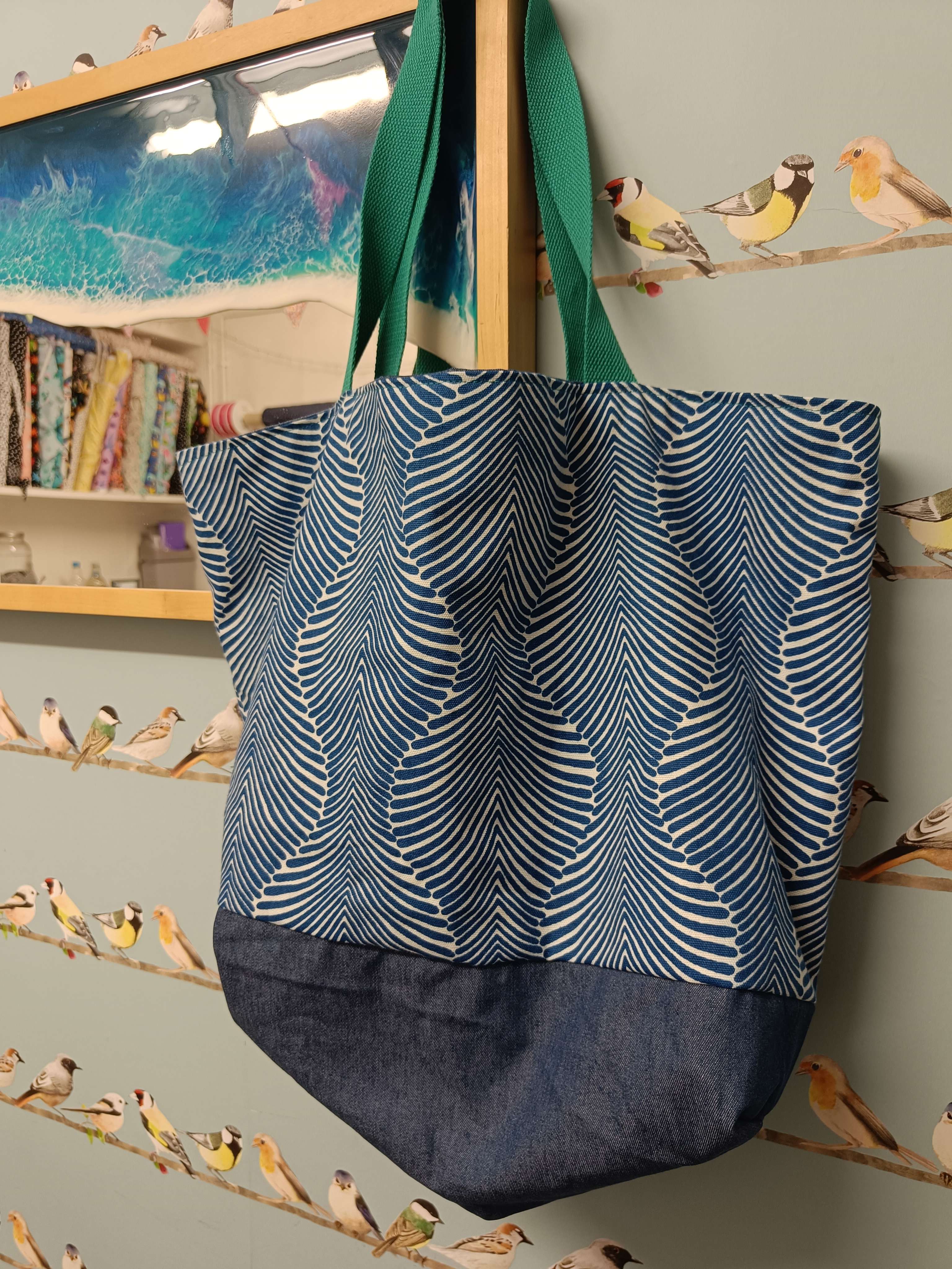 a handprinted summer canvas bag made by Gemma Forde hanging on the side of a wooden framed mirror