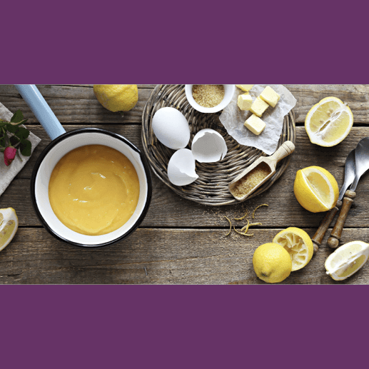 ingredients for lemon curd laid out on a wooden table