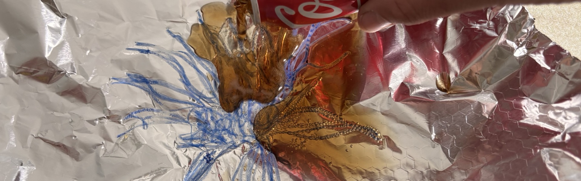 Main image: a line design drawn on foil, with Coca-Cola being poured over it for a chemical reaction to occur and leave a print. Lithography printmaking techniques at home.