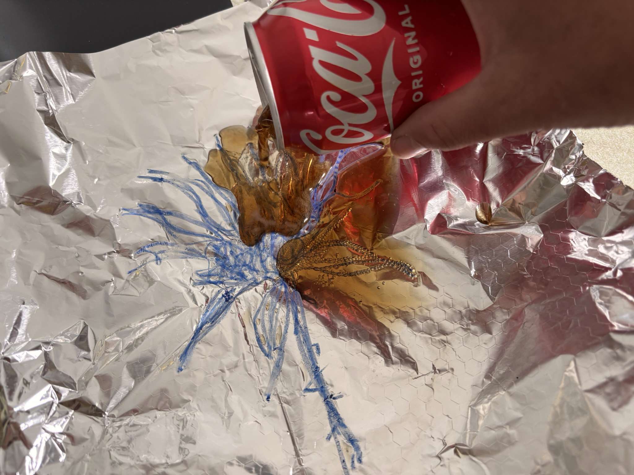 Main image: a line design drawn on foil, with Coca-Cola being poured over it for a chemical reaction to occur and leave a print. Lithography printmaking techniques at home.