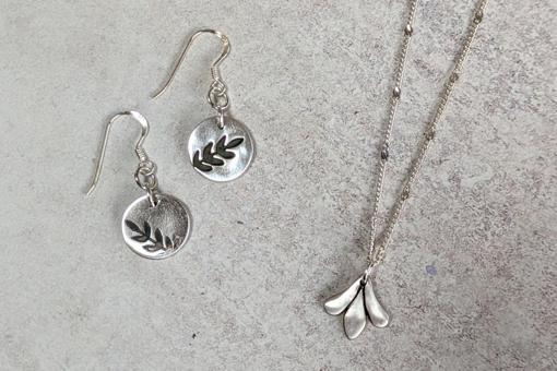 Silver clay jewellery, handmade pendants in earrings and a necklace with a leaf design imprinted.