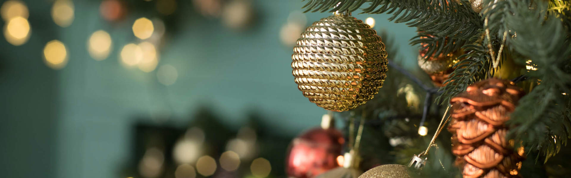 a close up of Christmas tree ornaments hanging on a tree