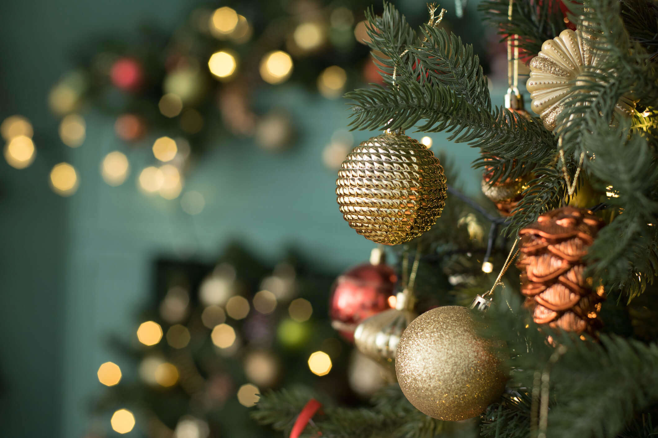 a close up of Christmas tree ornaments hanging on a tree