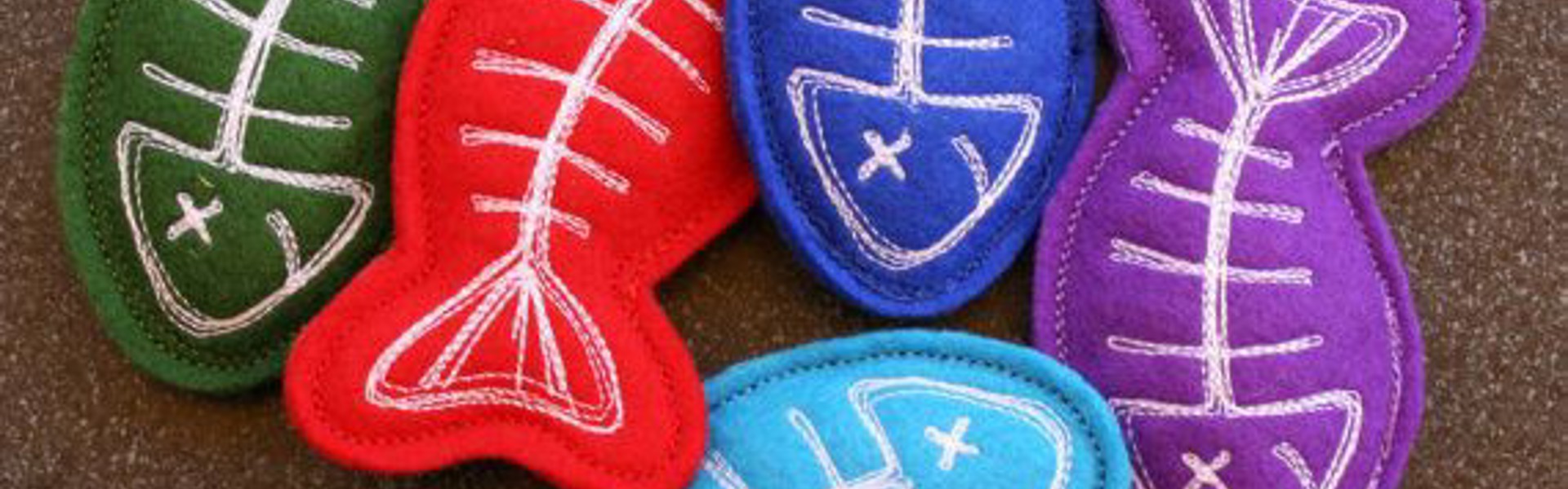 Main Image;: Photo of DIY pet toys for cats, brightly coloured, handsewn fish cat toys.