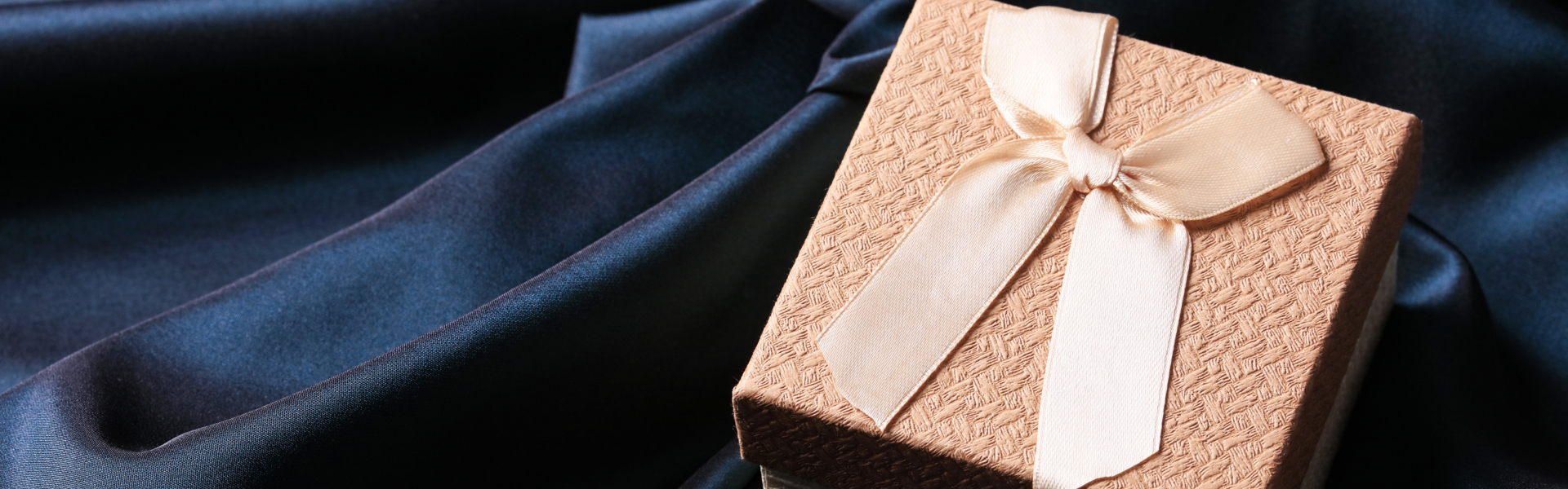 a peach coloured trinket box on a navy background