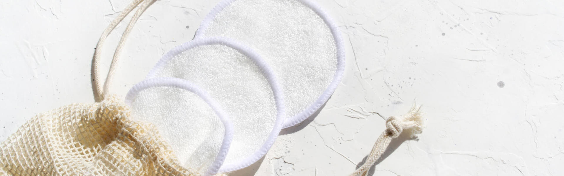 3 cotton reusable make up pads in a net bag