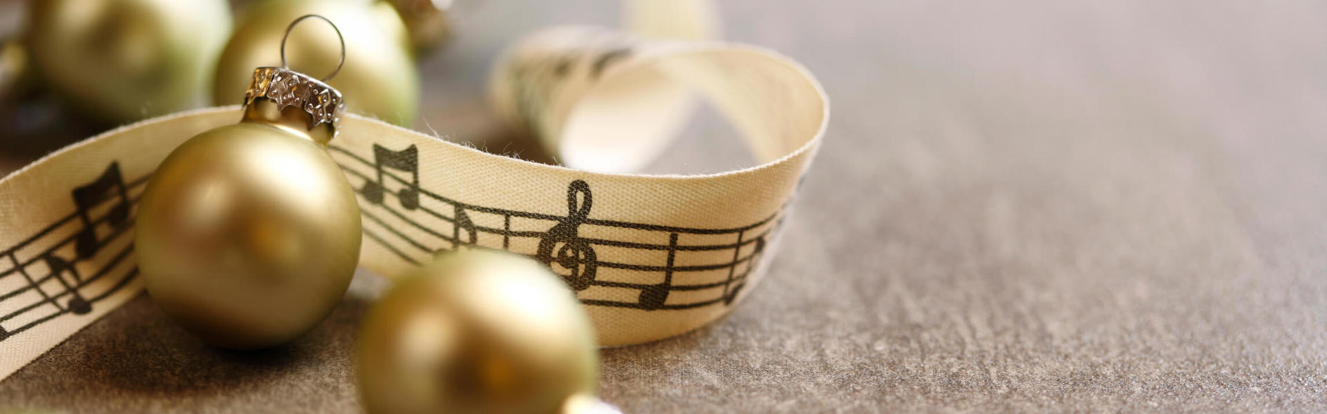 a close up of gold Christmas bells