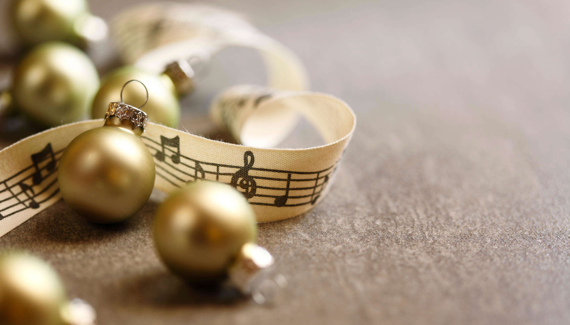 a close up of gold Christmas bells