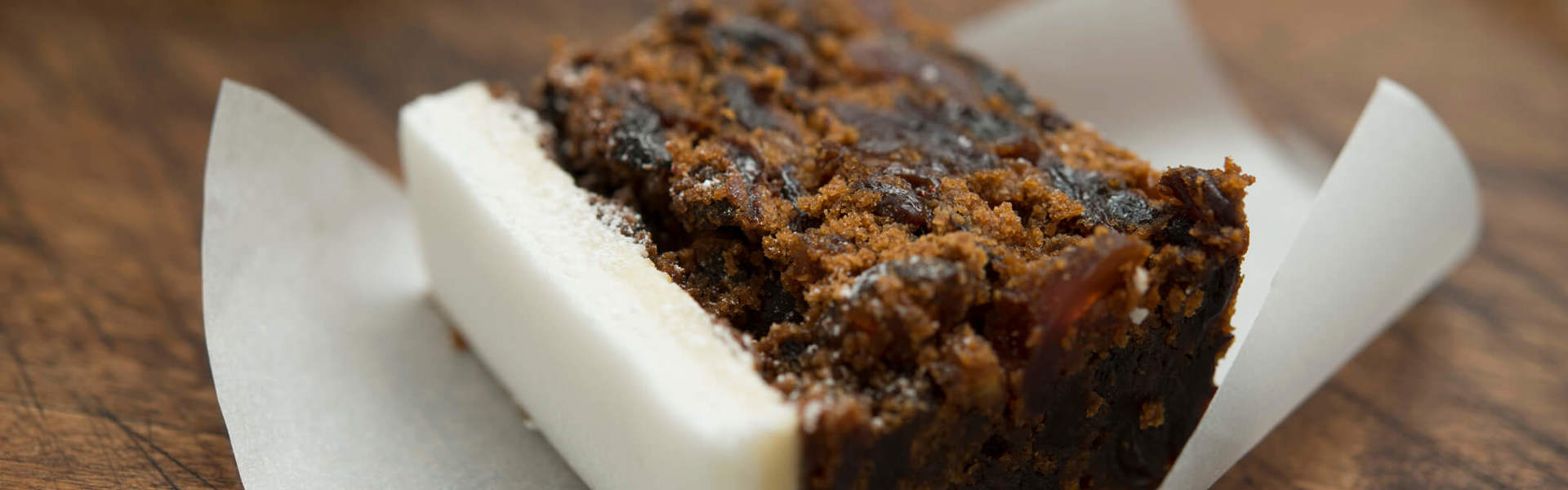 a slice of Christmas cake on a piece of white baking paper