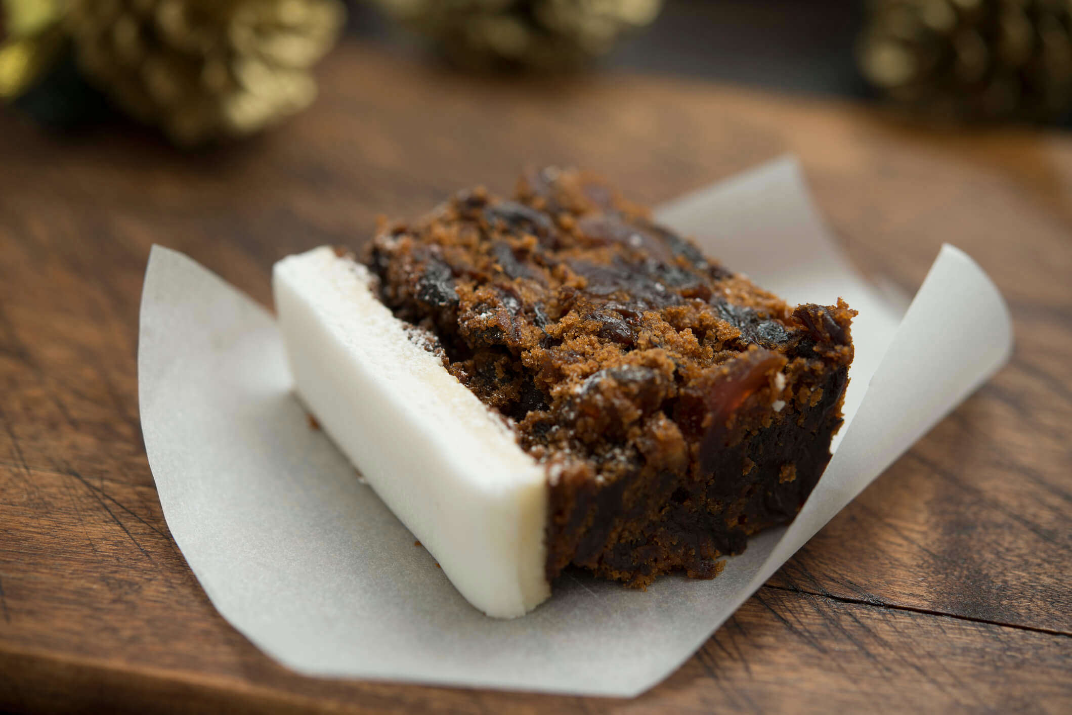 a slice of Christmas cake on a piece of white baking paper
