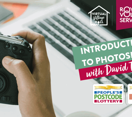 a person sat a work desk looking at a picture on a DSLR camera