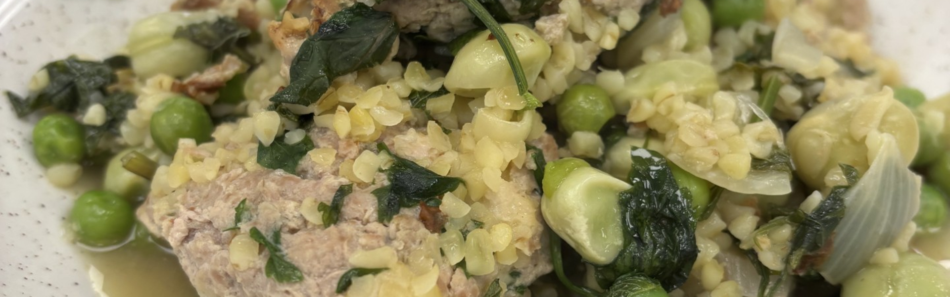Main Image: Healthy Turkey Meatballs With Bulghur Wheat And Broad Beans on a white plate, with a sprig of parsley on the top.