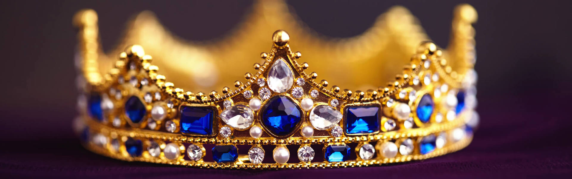 a gold grown with sapphire jewels
