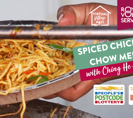 A person serving spiced chicken chow mein into a foil plate 