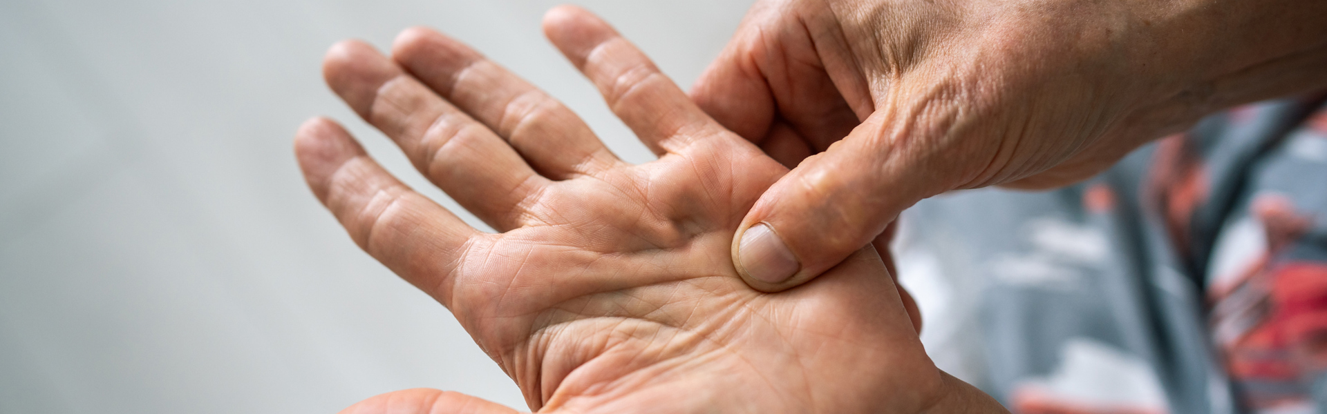 Person pinching an acupressure point in their hand, practising EFT Tapping for Feeling Overwhelmed.