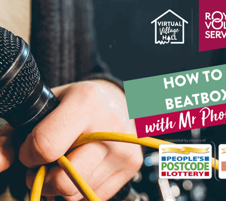 a hand holding a microphone with a yellow cord coming out of it