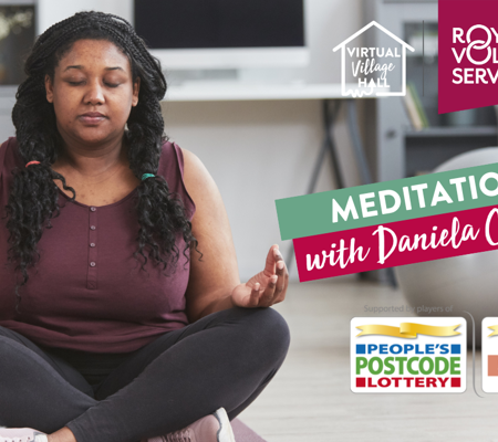 a woman sat cross legged with eyes closed in the living room meditating at home