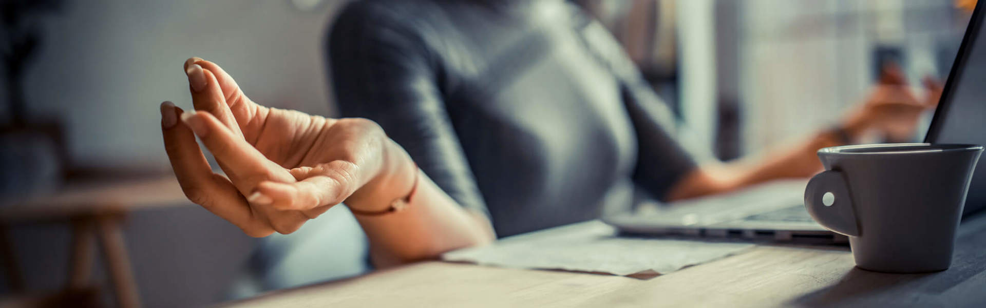 a close up of a hand as they meditate at their desk