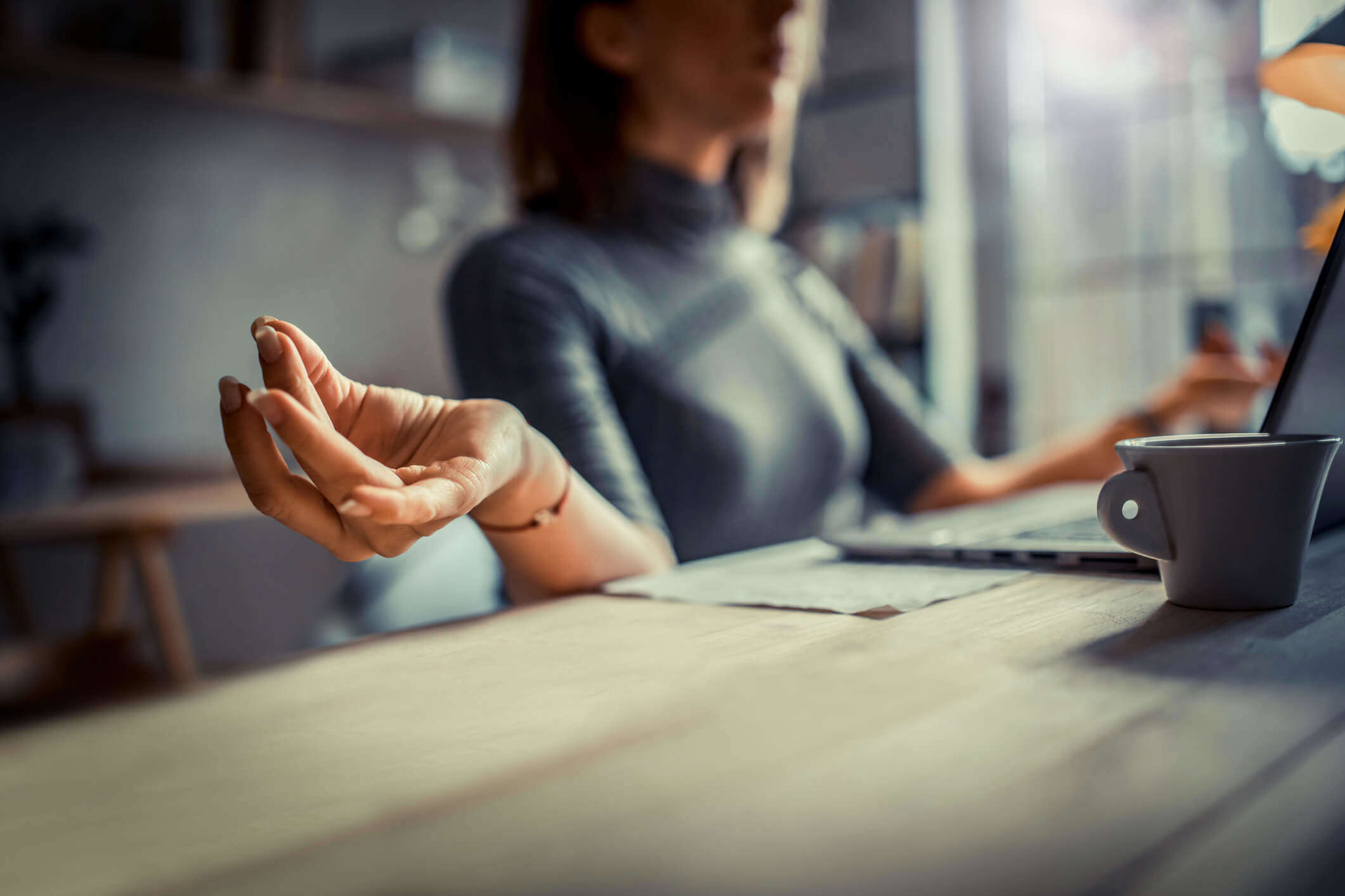 a close up of a hand as they meditate at their desk