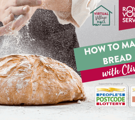 hands clapping flour over a freshly baked loaf of bread