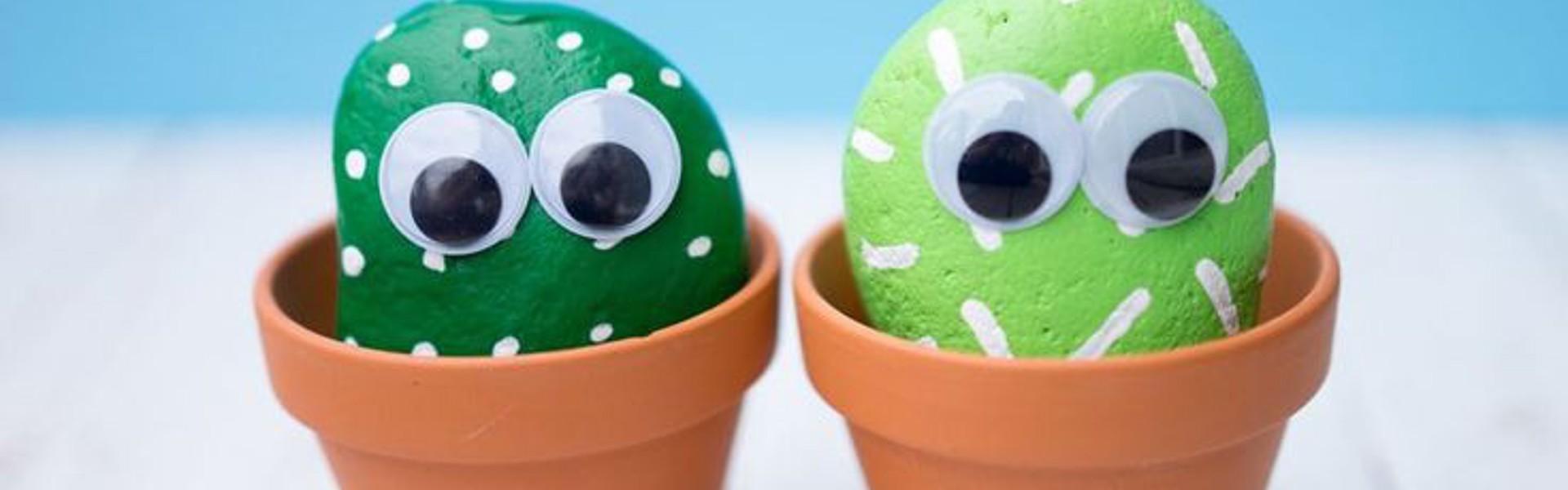 two small painted pebble cactus