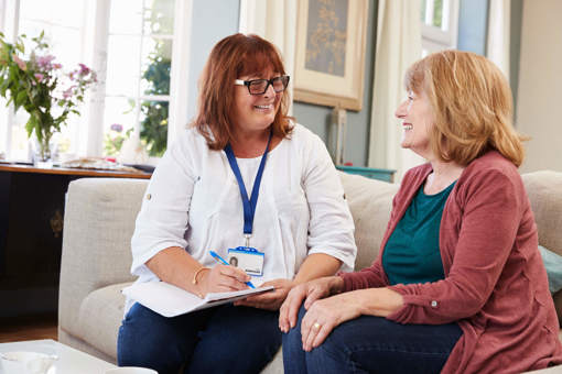 A social prescriber supporting a client in her home