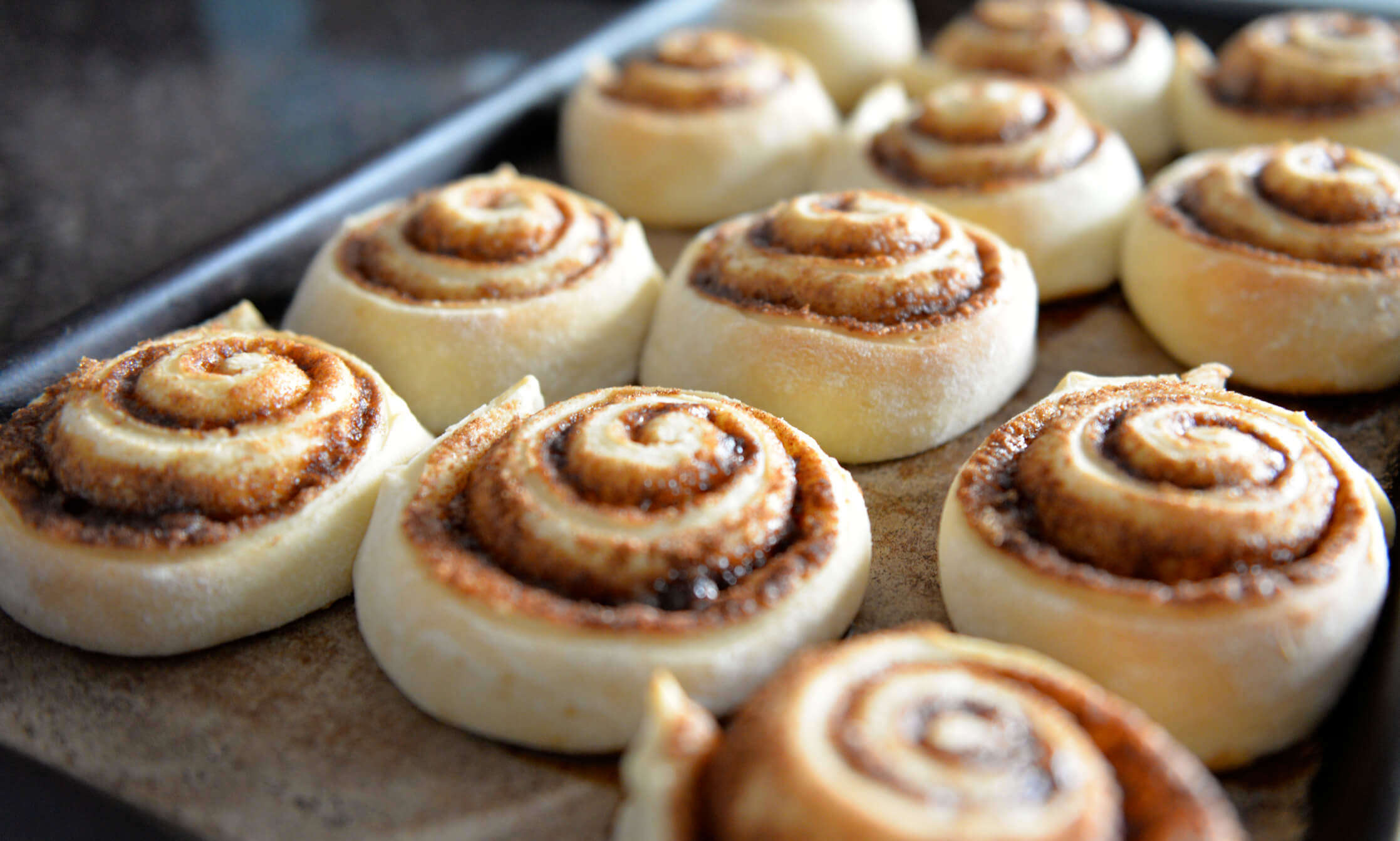 spiced cinnamon swirl buns on a baking tray