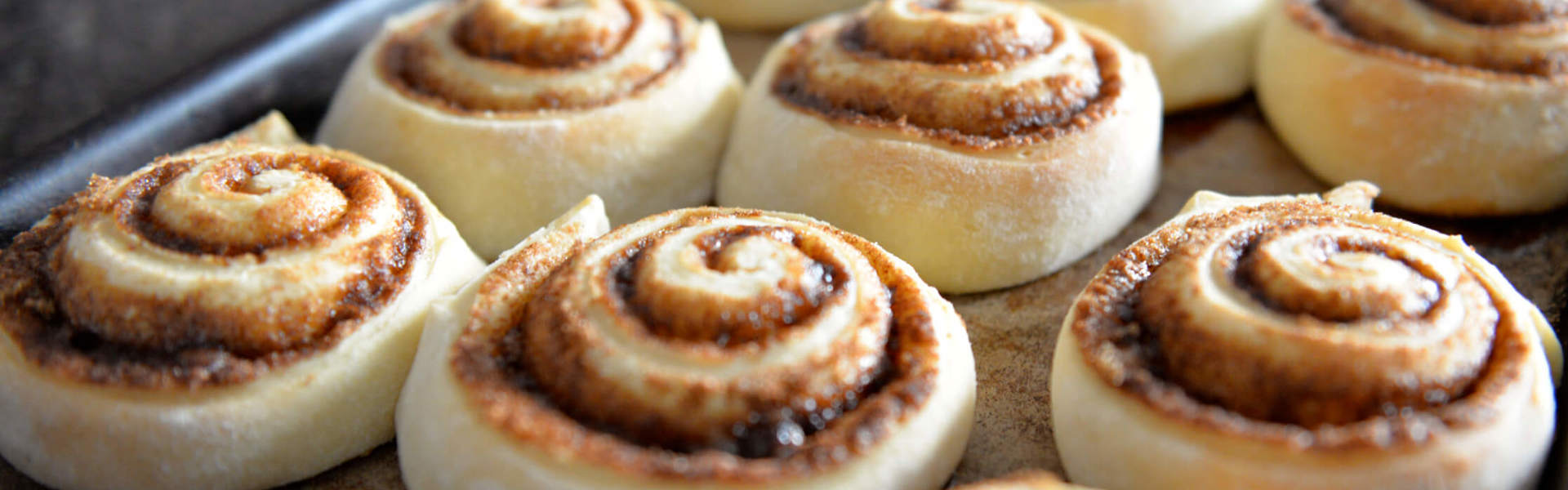 spiced cinnamon swirl buns on a baking tray