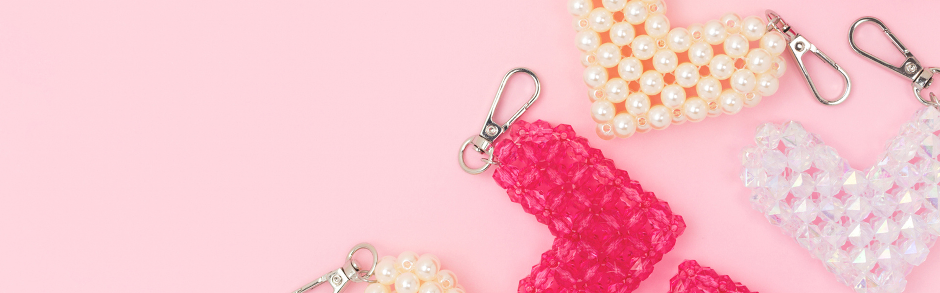 white pink and peach beaded handmade keyrings on a pink background