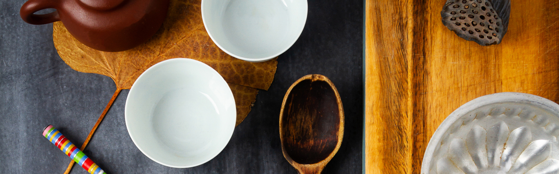 Afternoon tea set up, middle eastern style, with a small brown teapot on a leaf.