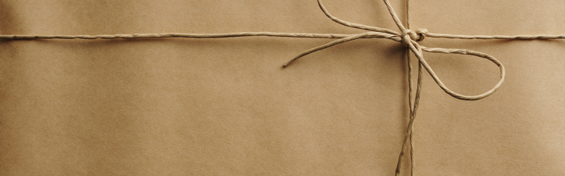 Brown paper wrapped in brown twine in a bow